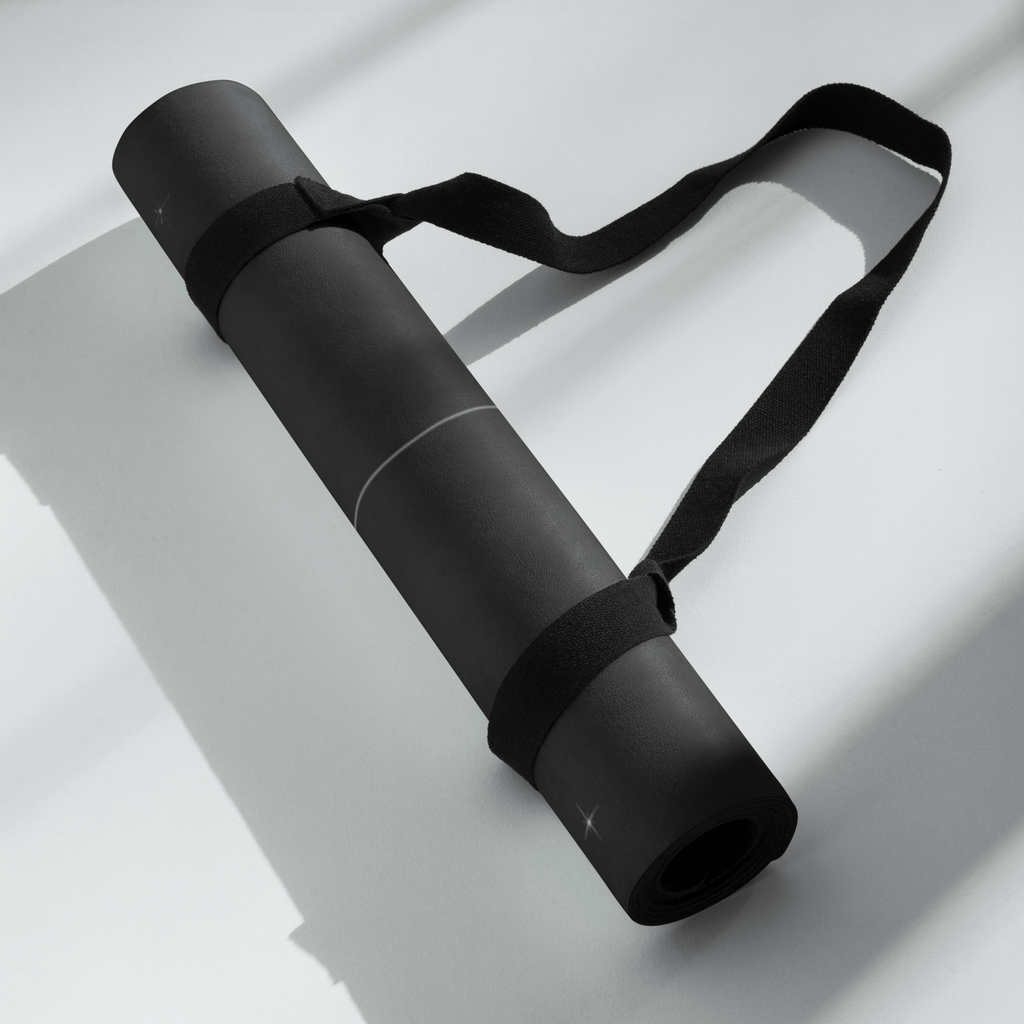 Hot Yoga Mat - Cosmic Stillness | MIYRA® rolled up with a strap, showcasing its portable design for towel-free hot yoga.
