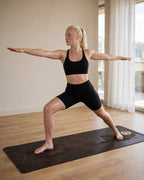 Woman practicing yoga on the Best Yoga Mat For Hot Yoga in Espresso Ivory Moon color.