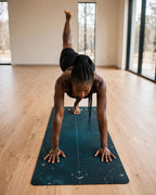 Best Yoga Mat For Hot Yoga featuring a teal lunar phases design in a dynamic yoga pose.