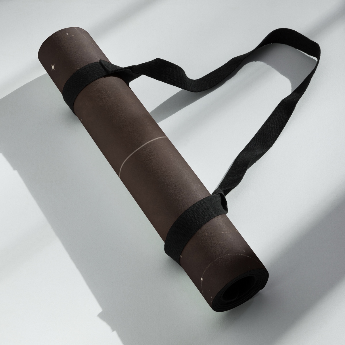 Hot Yoga Mat - Espresso Ivory Moon rolled up with a strap, ideal for Best Yoga Mat For Hot Yoga enthusiasts.