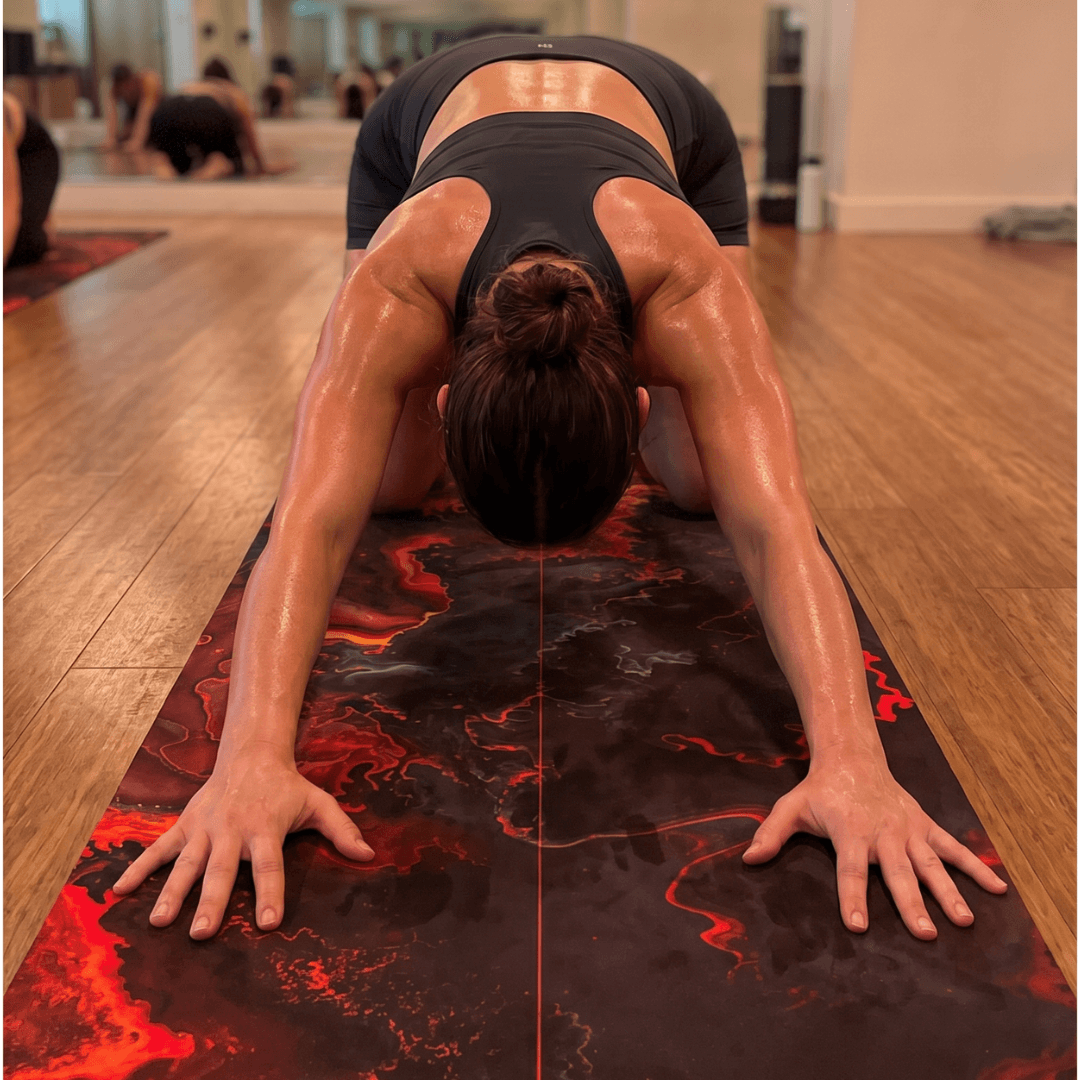 Practicing on the Hot Yoga Mat - Obsidian Flame | MIYRA®, featuring sweat-activated grip and non-slip performance.