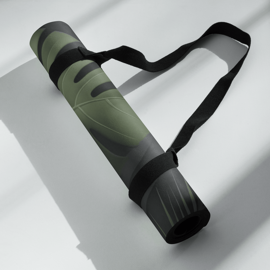 Hot Yoga Mat - Tropical Shadow | MIYRA rolled up with a strap, showcasing its eco-friendly design and vibrant tropical pattern.