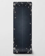 Best yoga mat for hot yoga with a charcoal background and decorative ivy patterns.