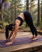 Woman practicing yoga on a Plum Wisteria yoga mat, emphasizing the Best Yoga Mat For Hot Yoga in a serene forest setting.