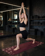 Person demonstrating a pose on the Best Yoga Mat For Hot Yoga in burgundy eucalyptus design.