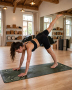 Woman practicing yoga on the Best Yoga Mat For Hot Yoga in Emerald Fern color.