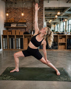Woman practicing yoga on the Best Yoga Mat For Hot Yoga in Emerald Fern color, showcasing stability and comfort.