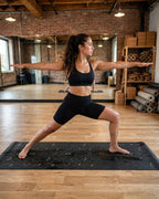 Woman practicing yoga on the Best yoga mat for hot yoga non slip hot yoga mat in a stylish studio.