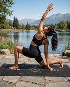 Woman practicing yoga on the Golden Eclipse mat by the lake, emphasizing the Best yoga mat for hot yoga.