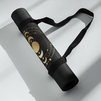 Hot Yoga Mat | Eclipse rolled with celestial design and black strap on a clean surface.